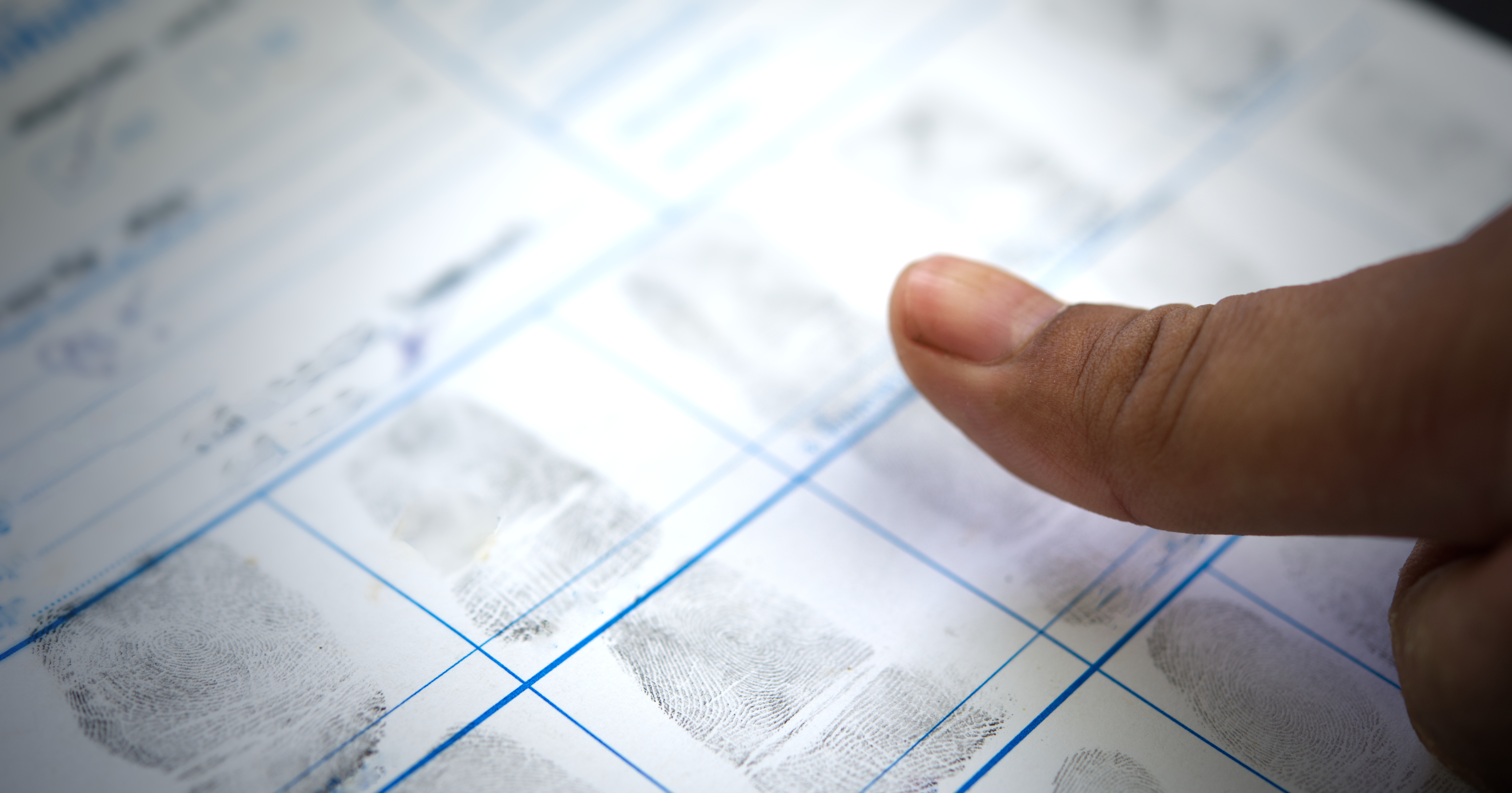 Thumb over fingerprinting document.